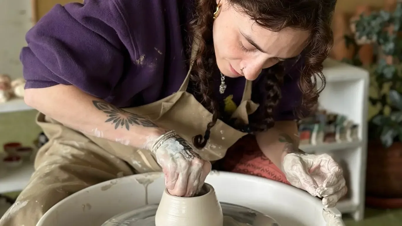 Kayla sharing clay art work from the five-week beginners pottery course.