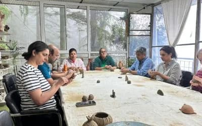 Hands shaping clay as a mindfulness and meditation practice in a pottery studio.