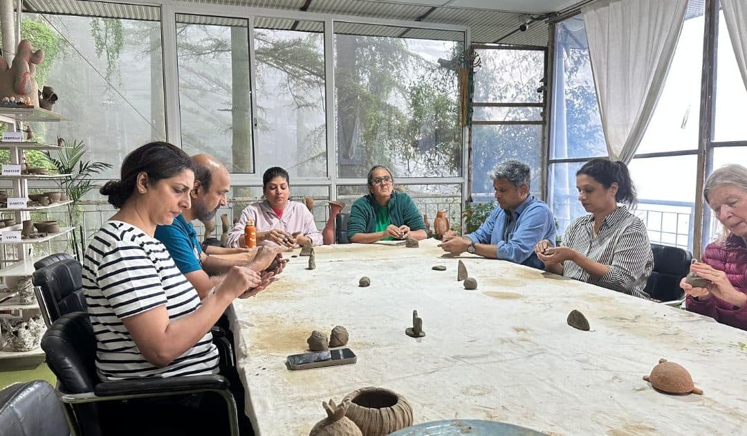 Clay meditation as a mindfulness practice with hands shaping clay in a pottery studio.