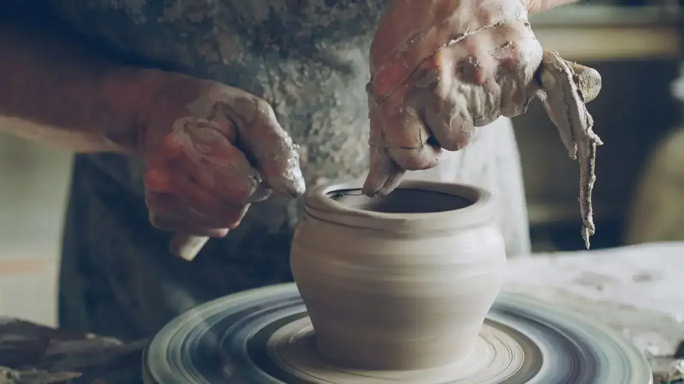 Wheel throwing workspace with pottery tools arranged for studio practice.