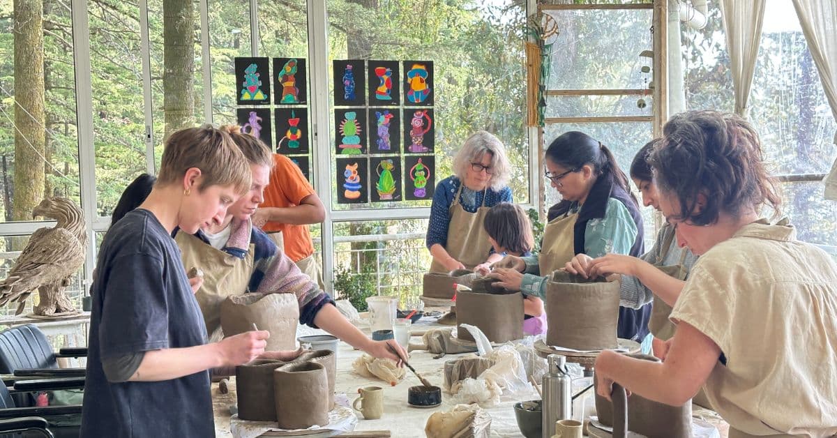 A group of artists building a sculpture at Dharamkot Studio.