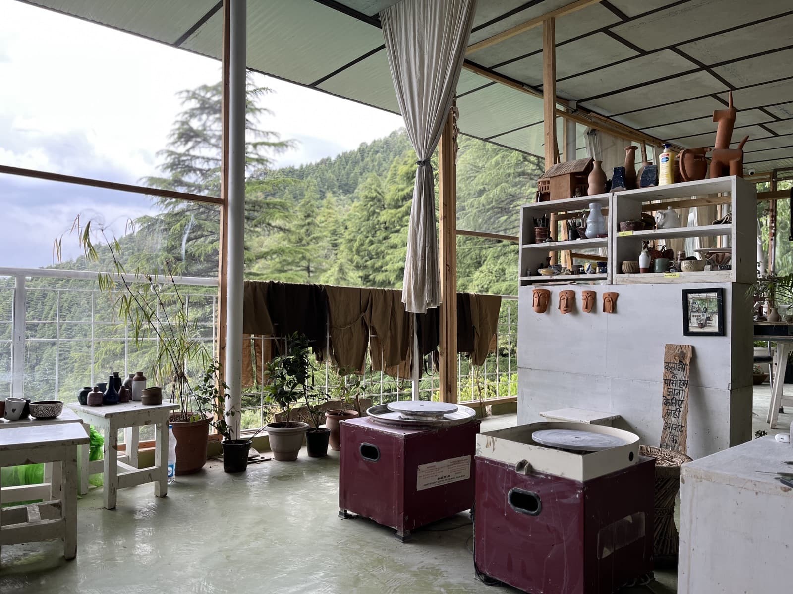 Working with clay during a pottery retreat at Dharamkot Studio.
