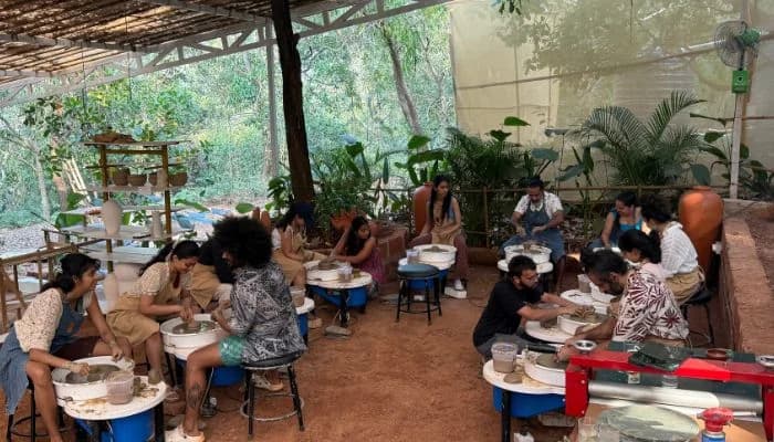 Participants learning pottery on the wheel during a 5-day pottery retreat in India.
