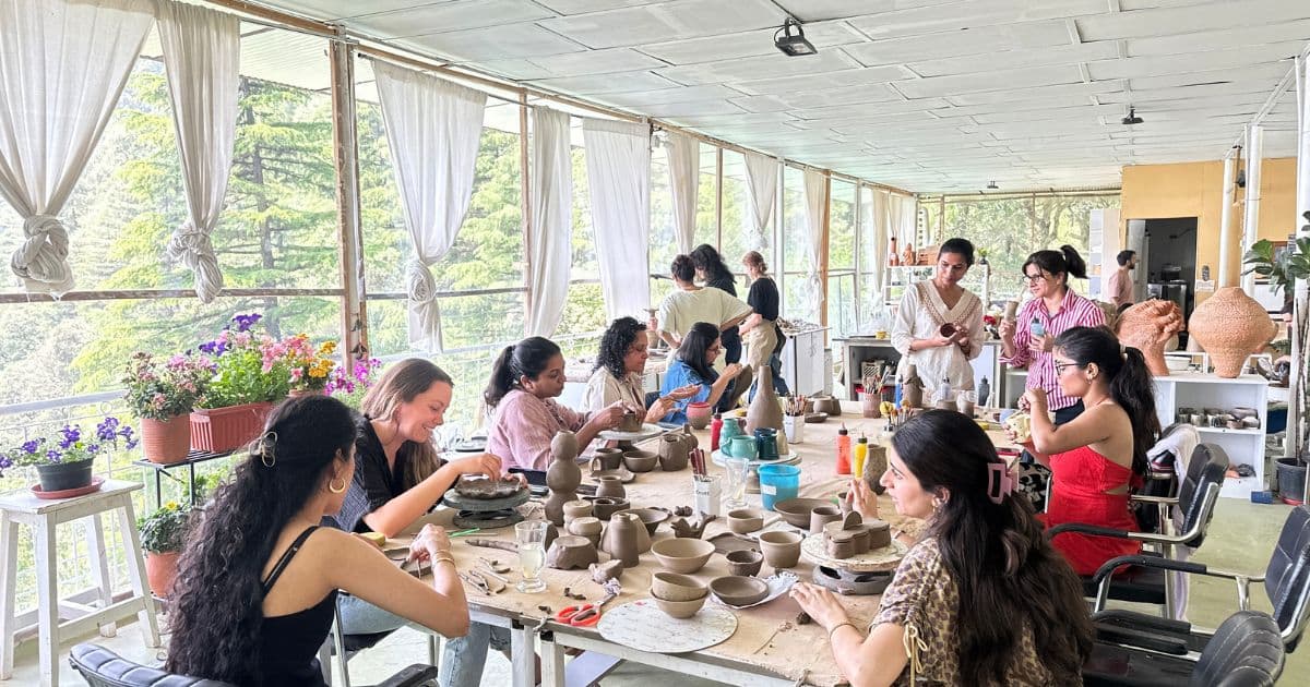 Creative pottery community at Dharamkot Studio retreat with participants learning together.