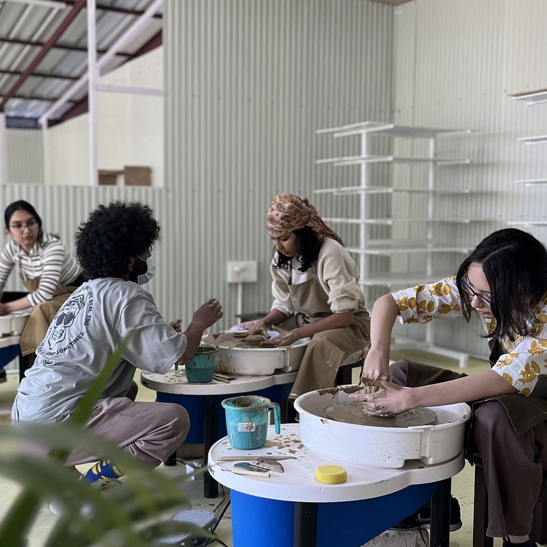Hands working with clay as a therapeutic pottery practice.