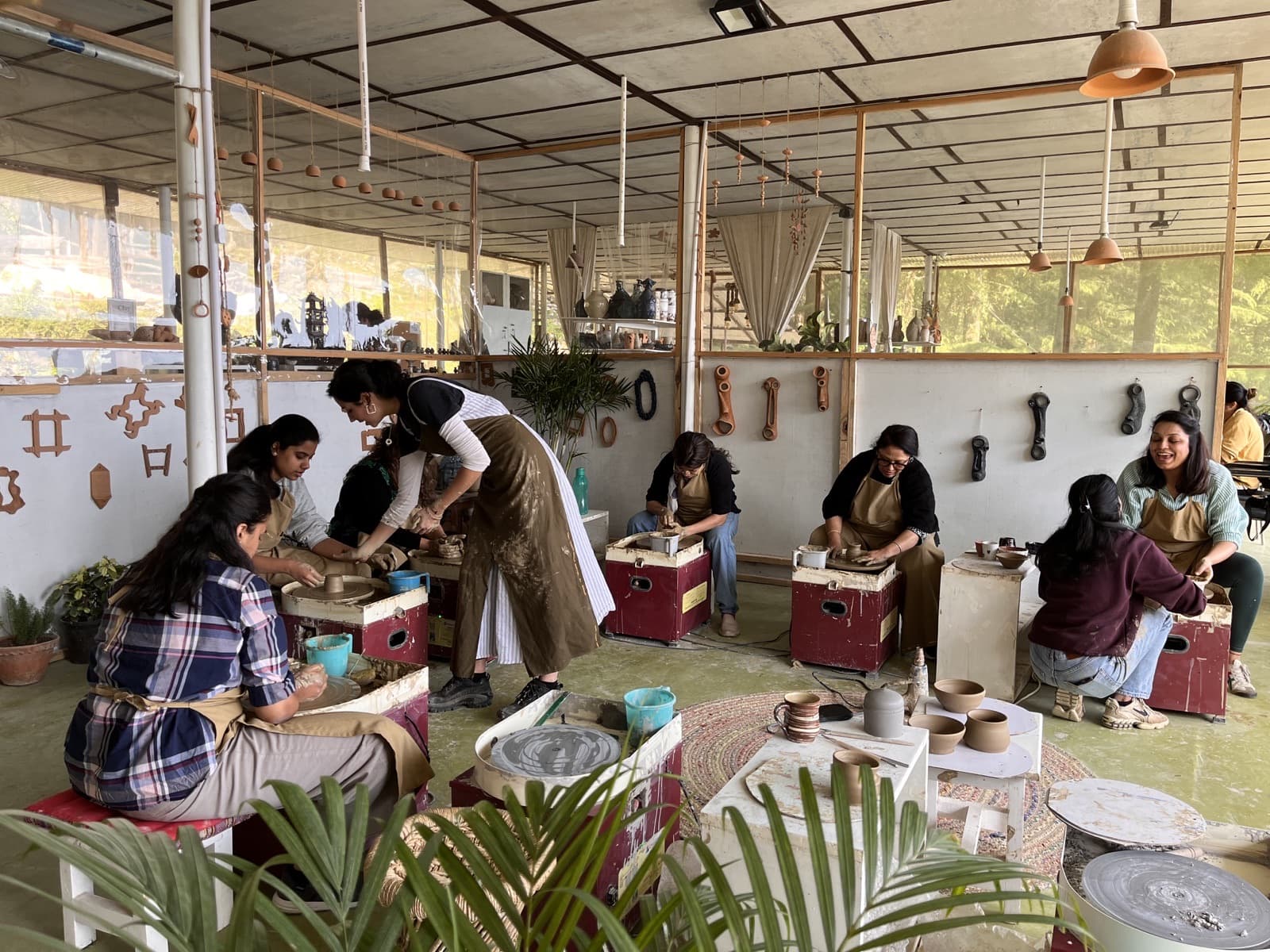 Pottery community members working and learning together.