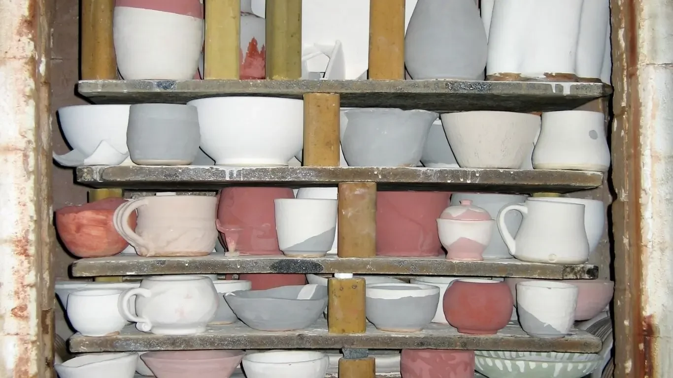 A pottery kiln and firing setup used for transforming clay into ceramic.