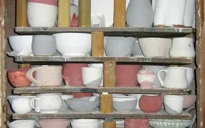 A pottery kiln and firing setup used for transforming clay into ceramic.
