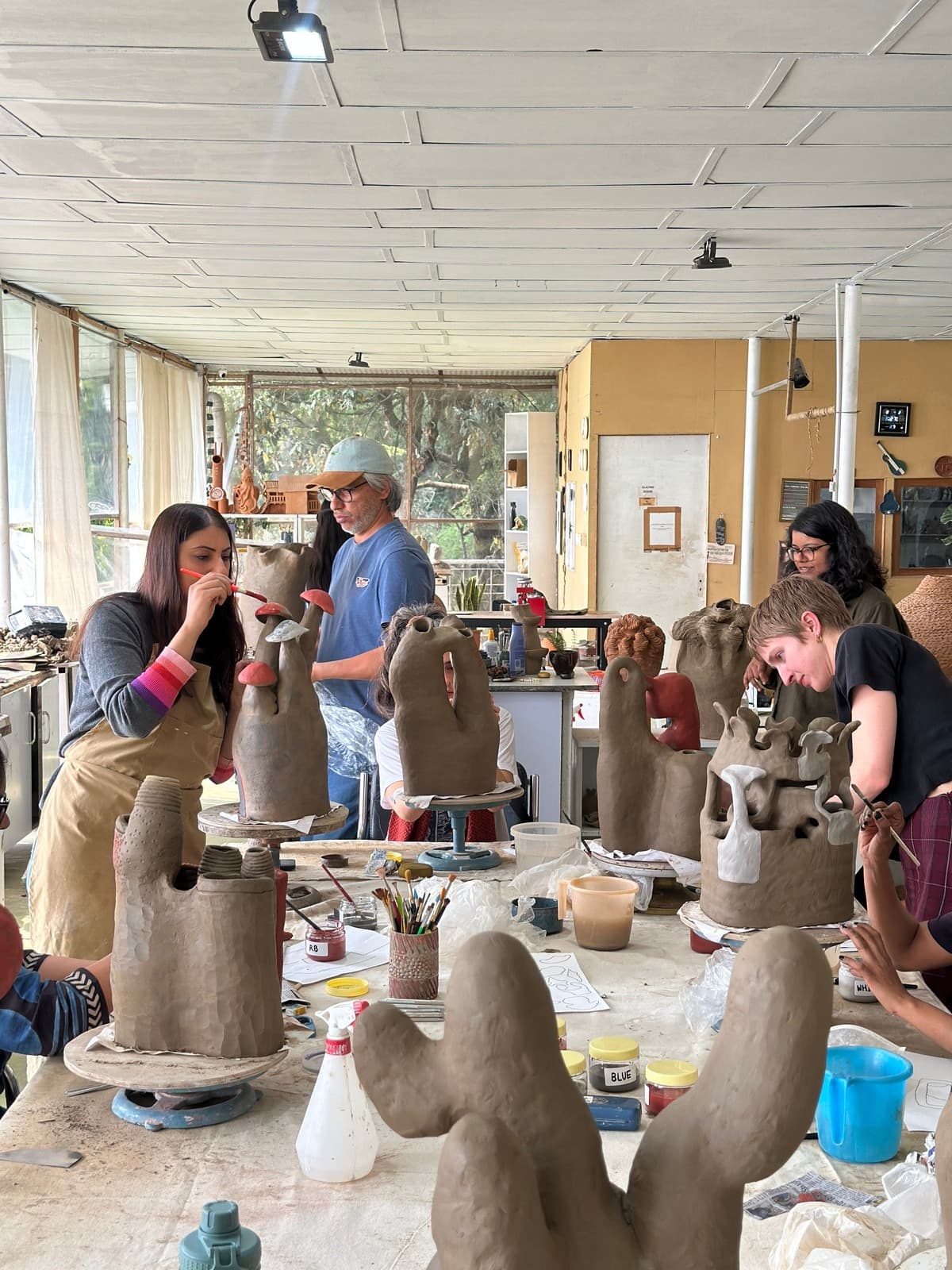 Artists in residence working with clay at Dharamkot Studio in Himachal Pradesh.