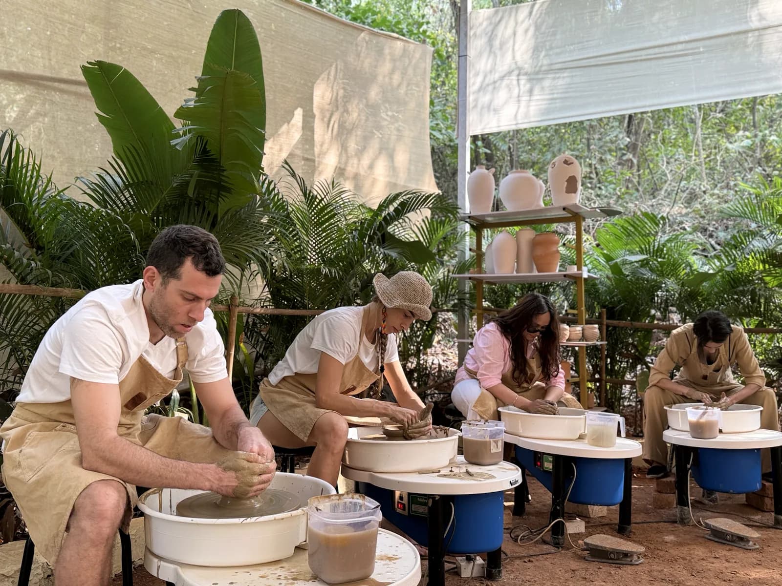 Students learning pottery wheel throwing during a beginner-friendly experience at Dharamkot Studio Goa.
