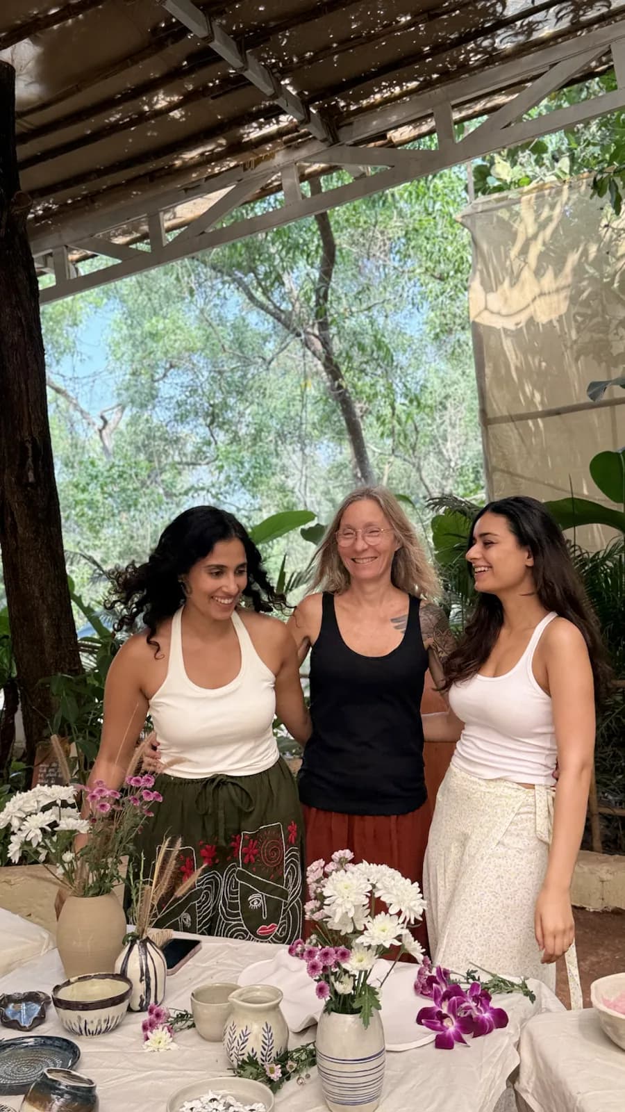 Pottery school course students smiling together at Dharamkot Studio Goa after a clay session.