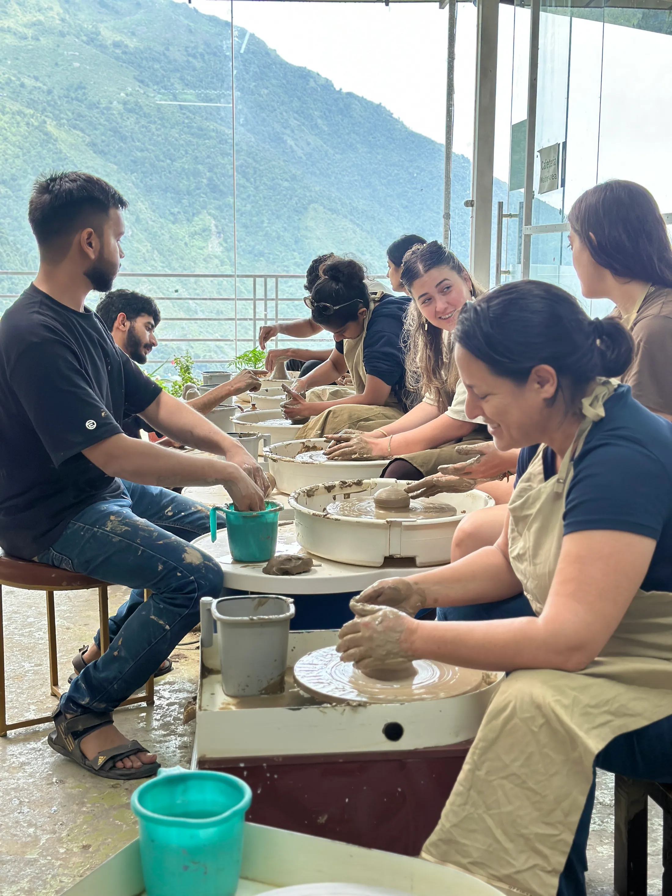 Clay class session at Dharamkot Studio in Himachal Pradesh with students learning pottery.