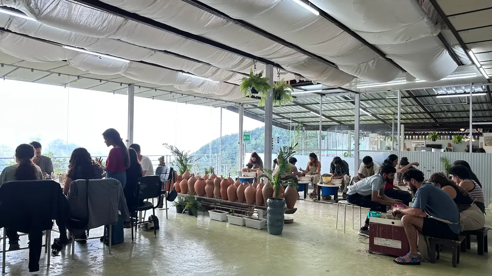 Participants gathered for pottery and art practice in Dharamkot Studio's community art space.
