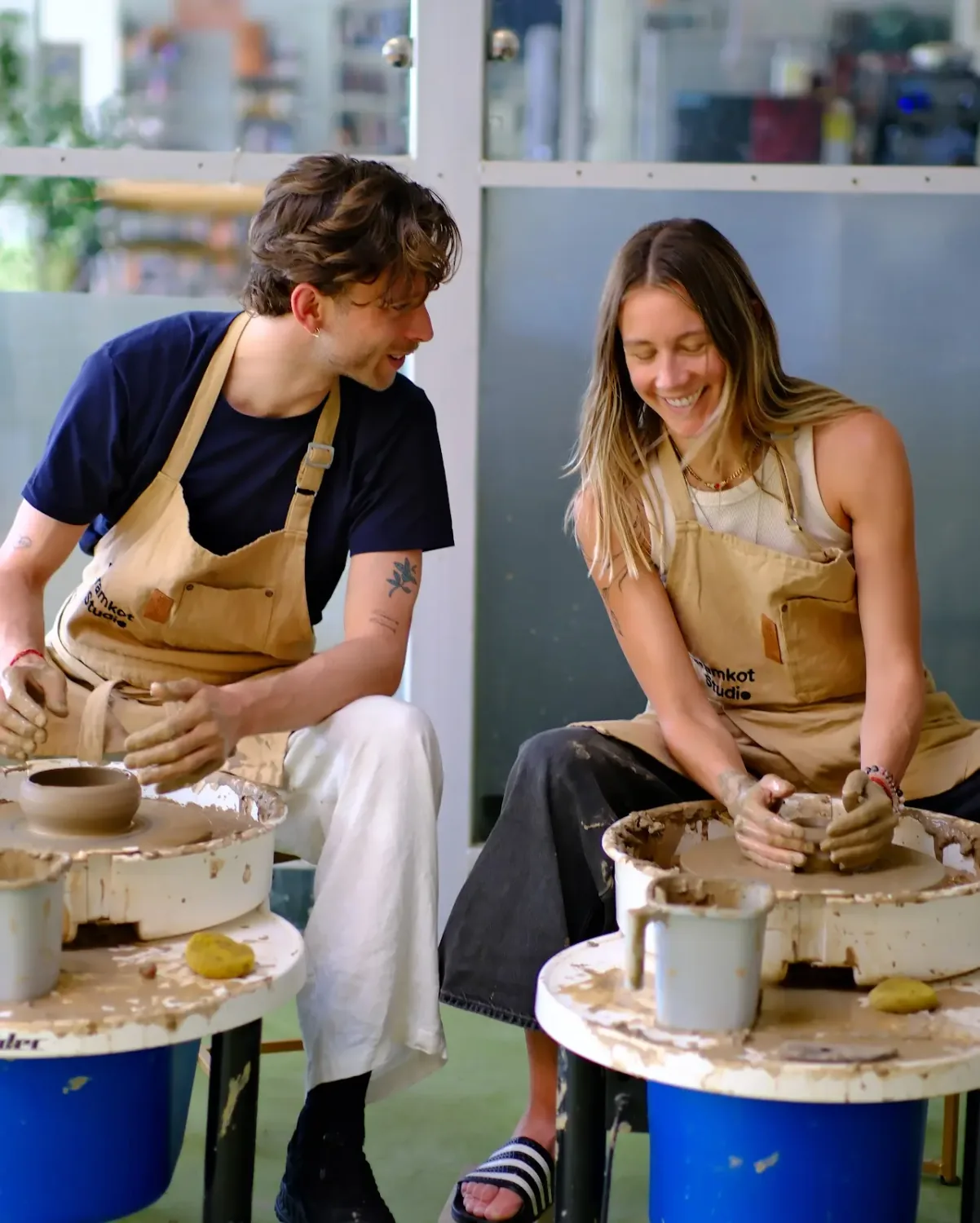 Students and visitors making pottery inside Dharamkot Studio's community art space.
