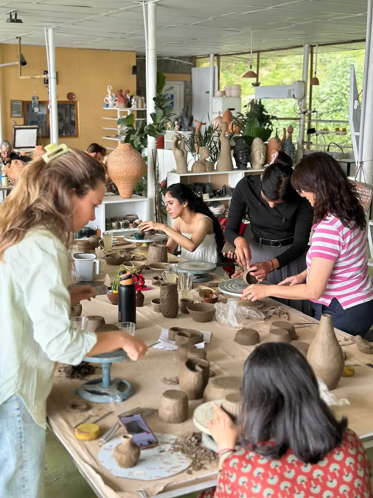 Participants working with clay during a guided studio practice session in Himachal Pradesh.