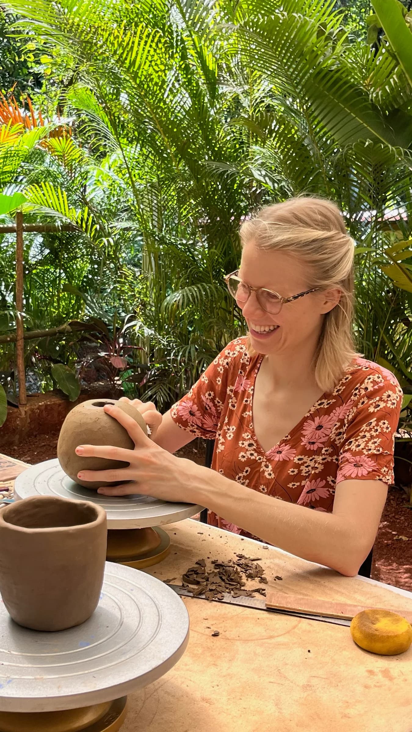 A participant carefully shaping a clay vessel during the Goa retreat.