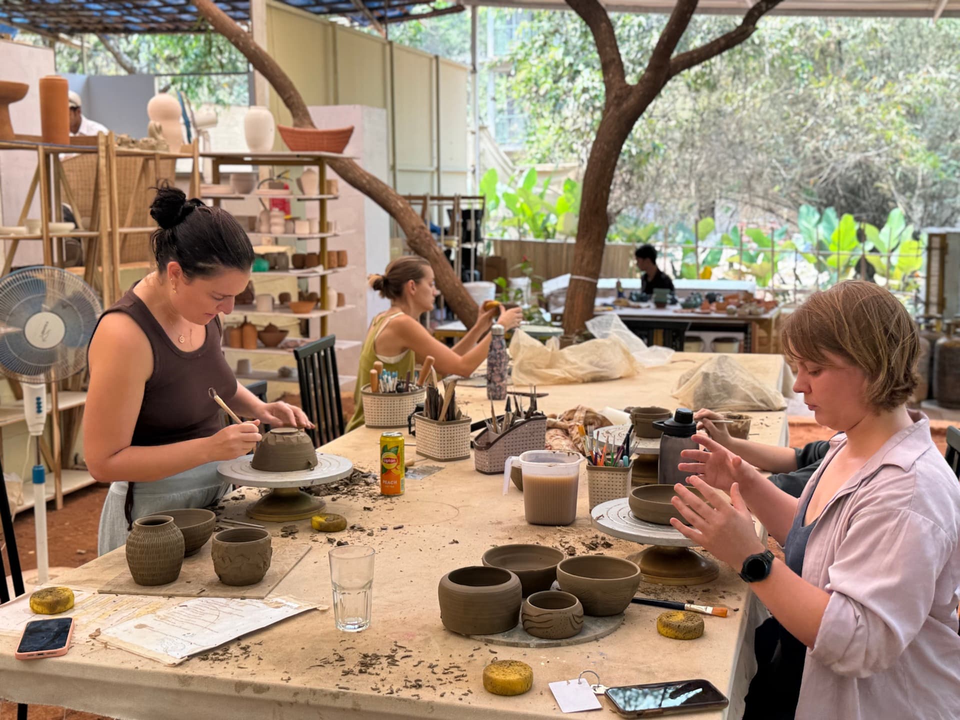 Participants learning pottery in a studio session in Goa.