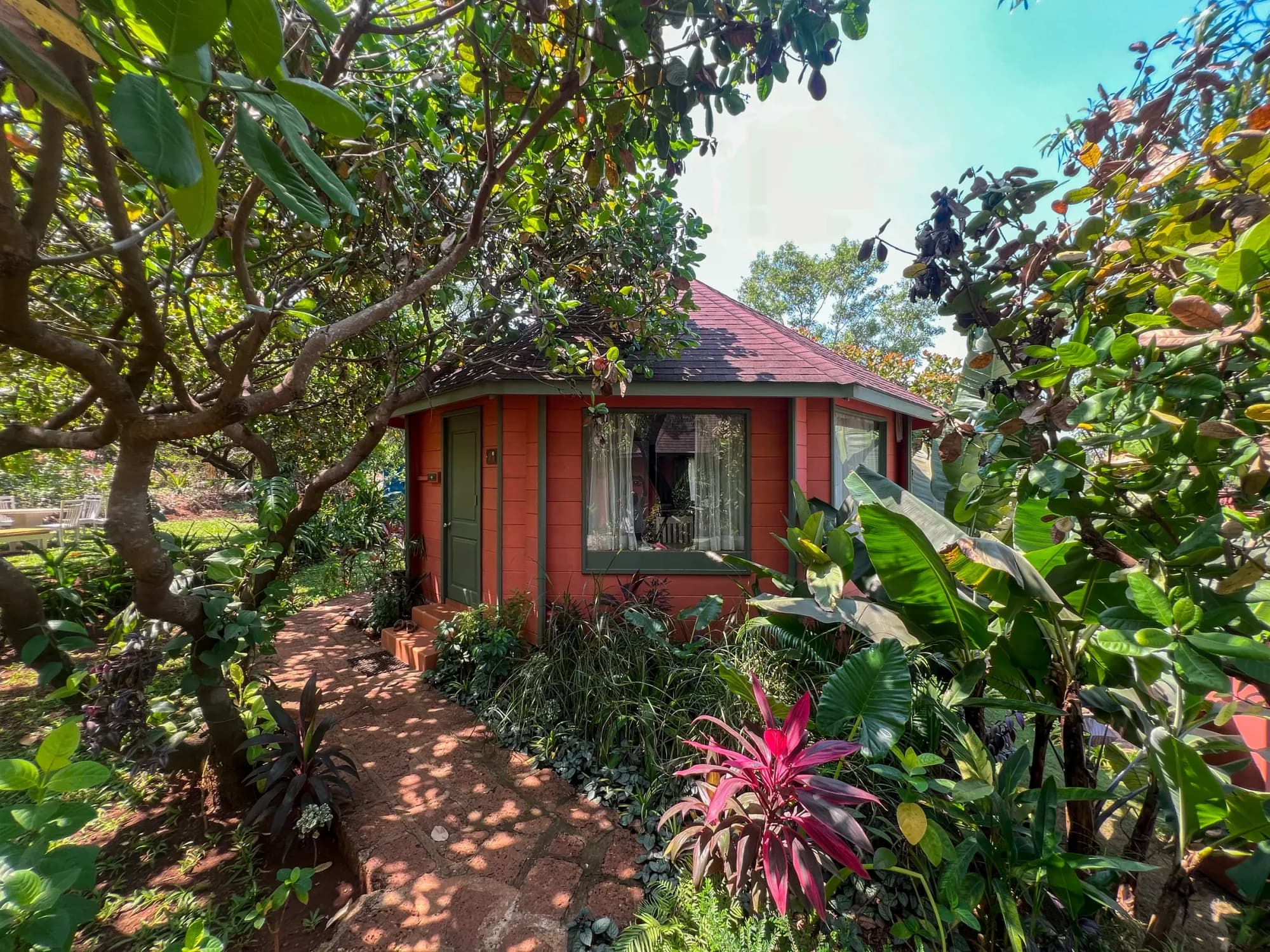 A tropical cottage and garden path at the Dharamkot Studio pottery retreat in Goa.