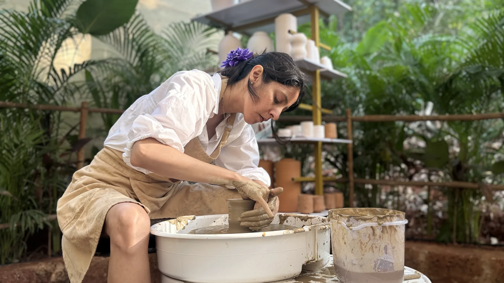 Participant learning wheel throwing during the Art of Wheel Throwing workshop at Dharamkot Studio in Goa.