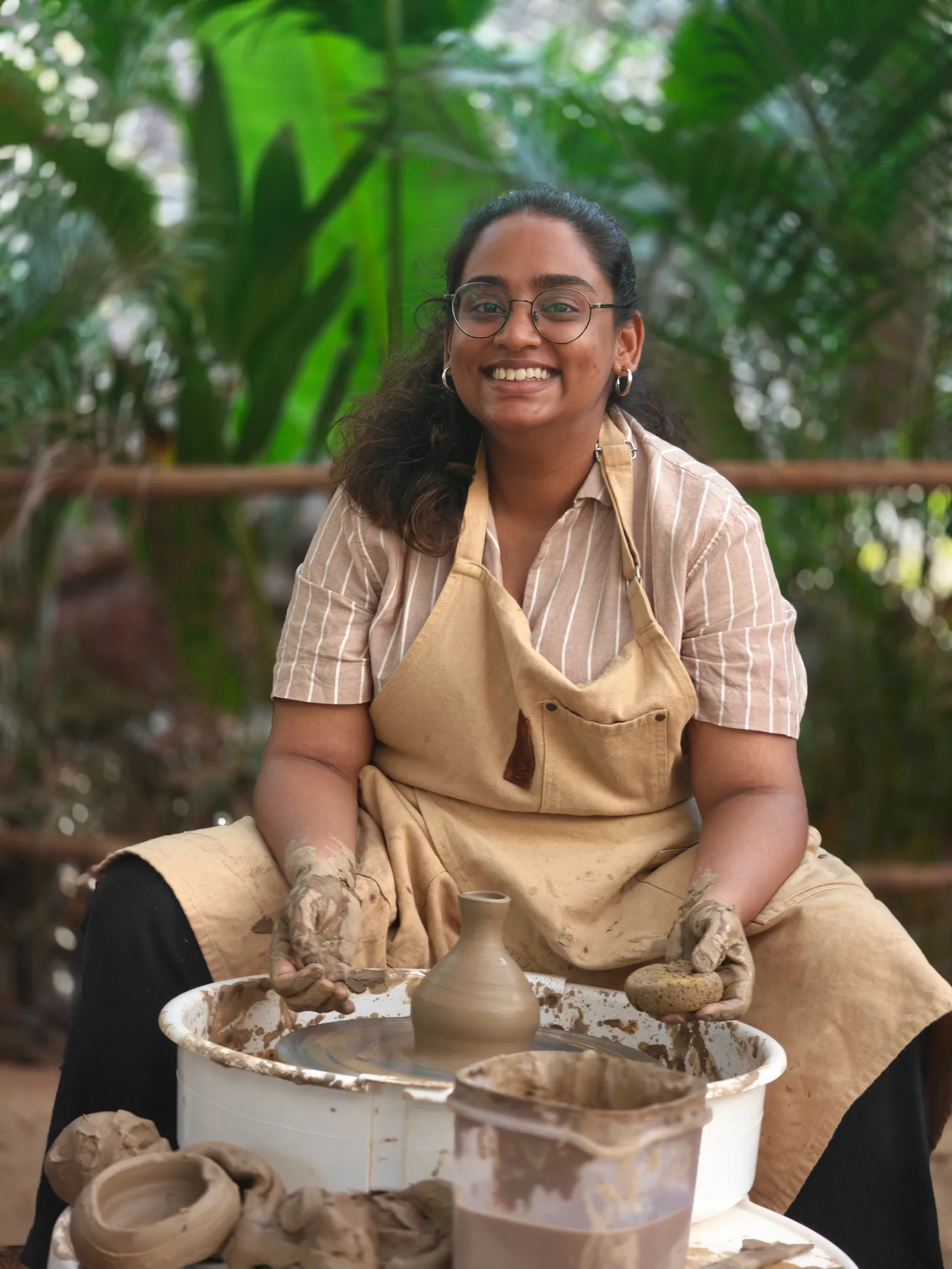 Participants practicing on pottery wheels in the outdoor Goa studio at Dharamkot Studio.