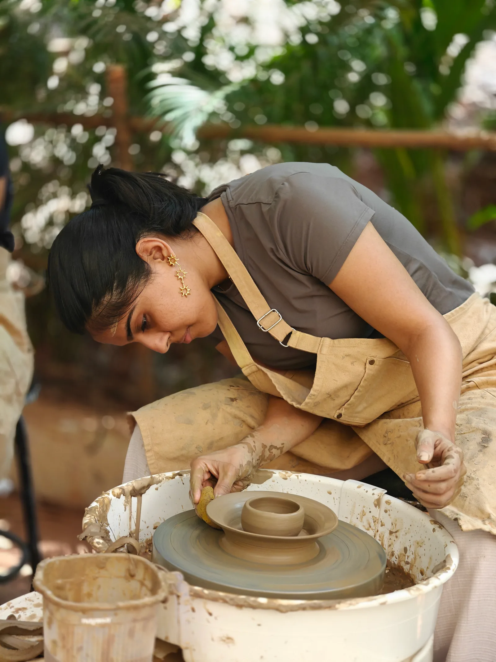 A beginner pottery wheel practice session with clay and pottery tools at Dharamkot Studio in Goa.