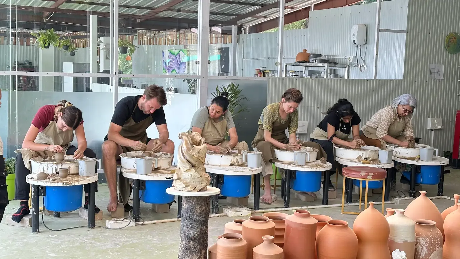 Group pottery wheel experience in the mountain studio at Dharamkot Studio Himachal Pradesh.