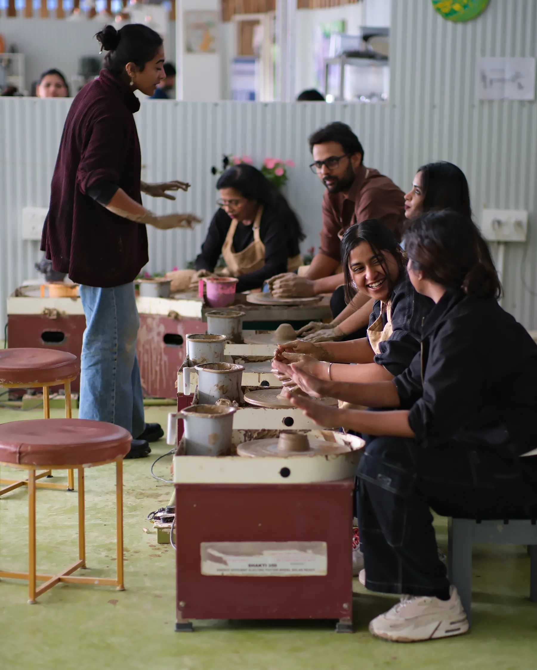 Students practicing wheel throwing during the Art of Wheel Throwing workshop at Dharamkot Studio in Himachal Pradesh.