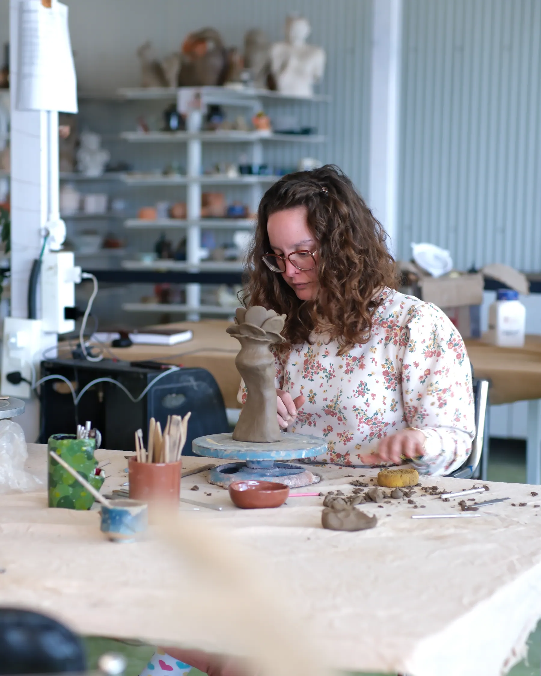 Participant shaping a hand-built clay sculpture during the Sculpt & Shape workshop at Dharamkot Studio in Himachal Pradesh.