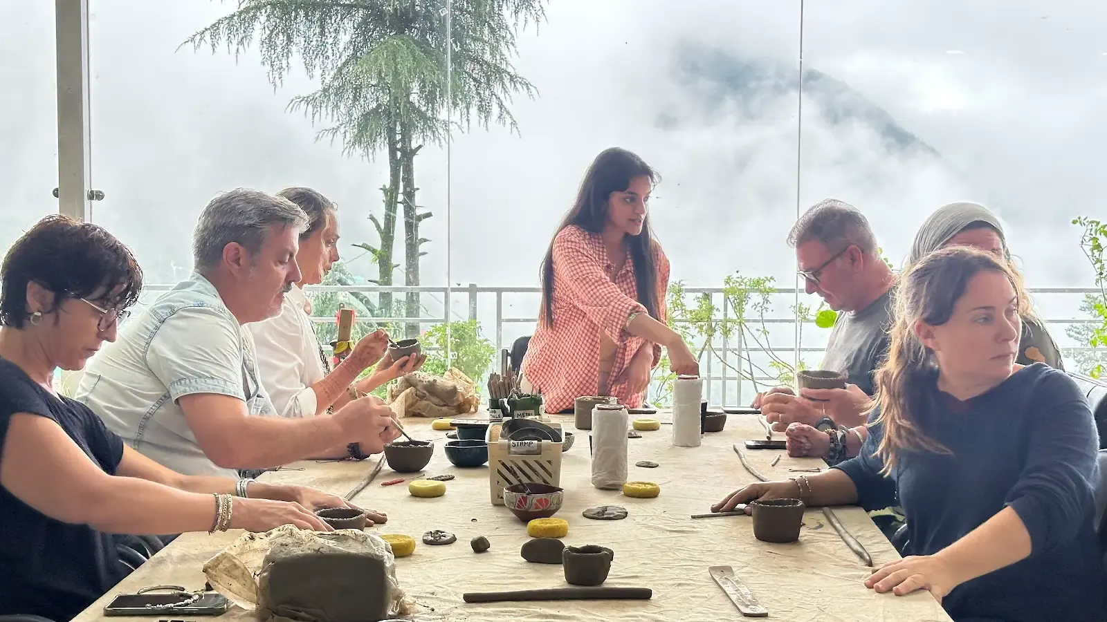 Group handbuilding clay together in the mountain studio during the Himachal Sculpt & Shape workshop.