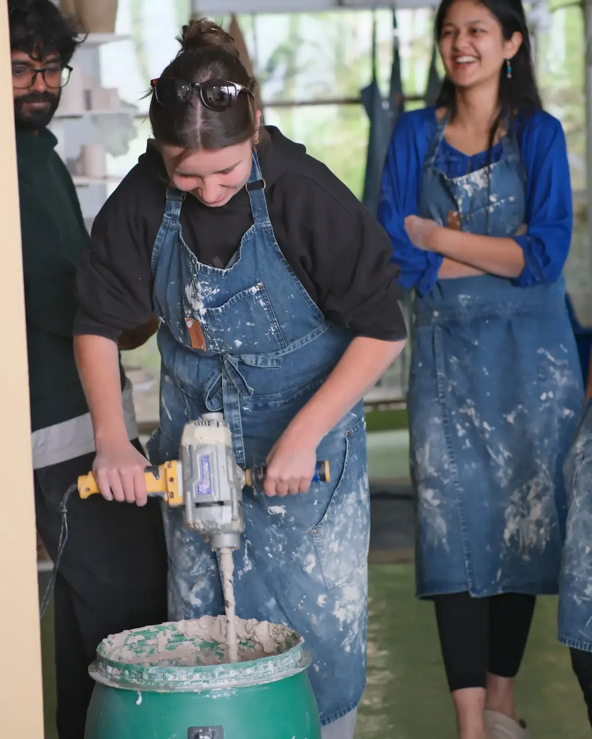 Pottery school participant preparing clay during a hands-on ceramic course session.