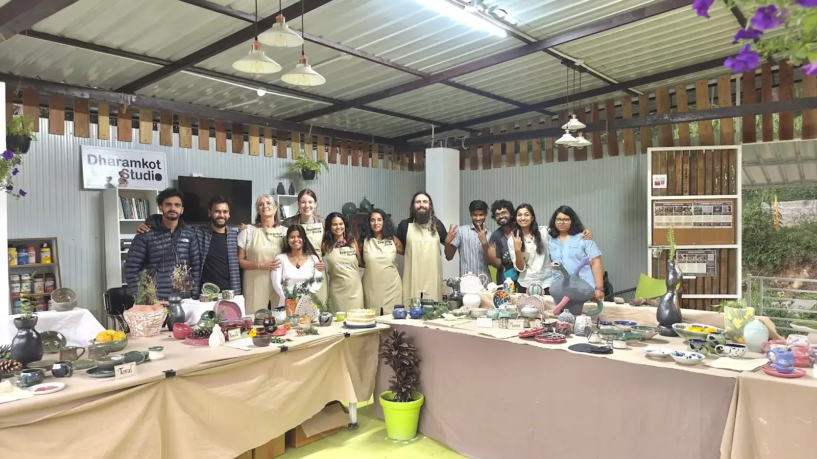 Pottery school students and finished ceramics inside Dharamkot Studio's five-week pottery course space.