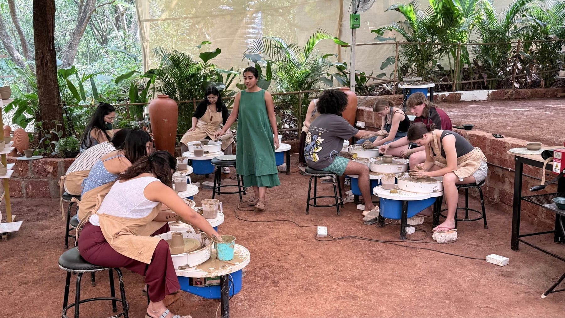 People learning pottery together inside Dharamkot Studio.